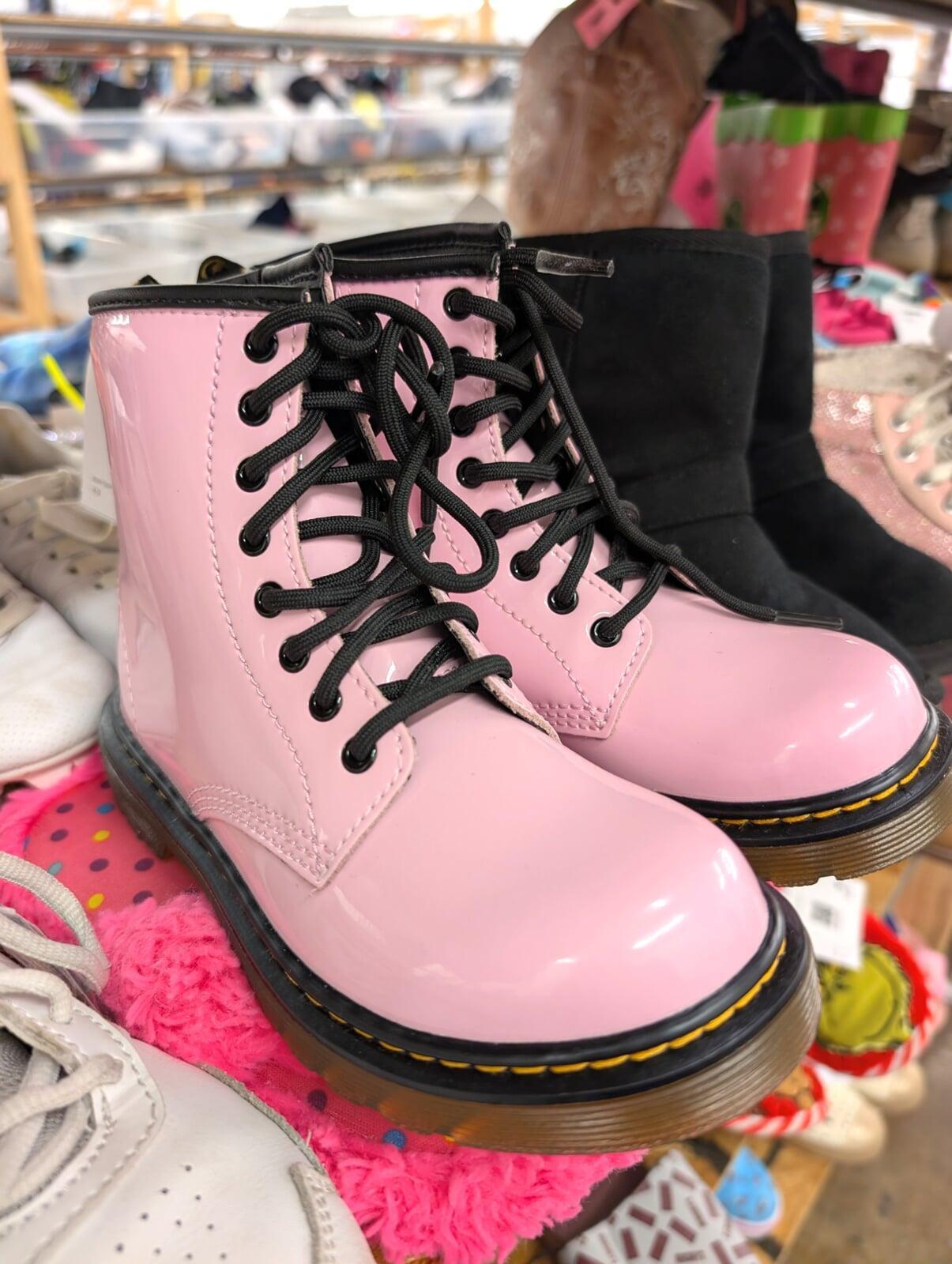 Pink boots sit on a store shelf
