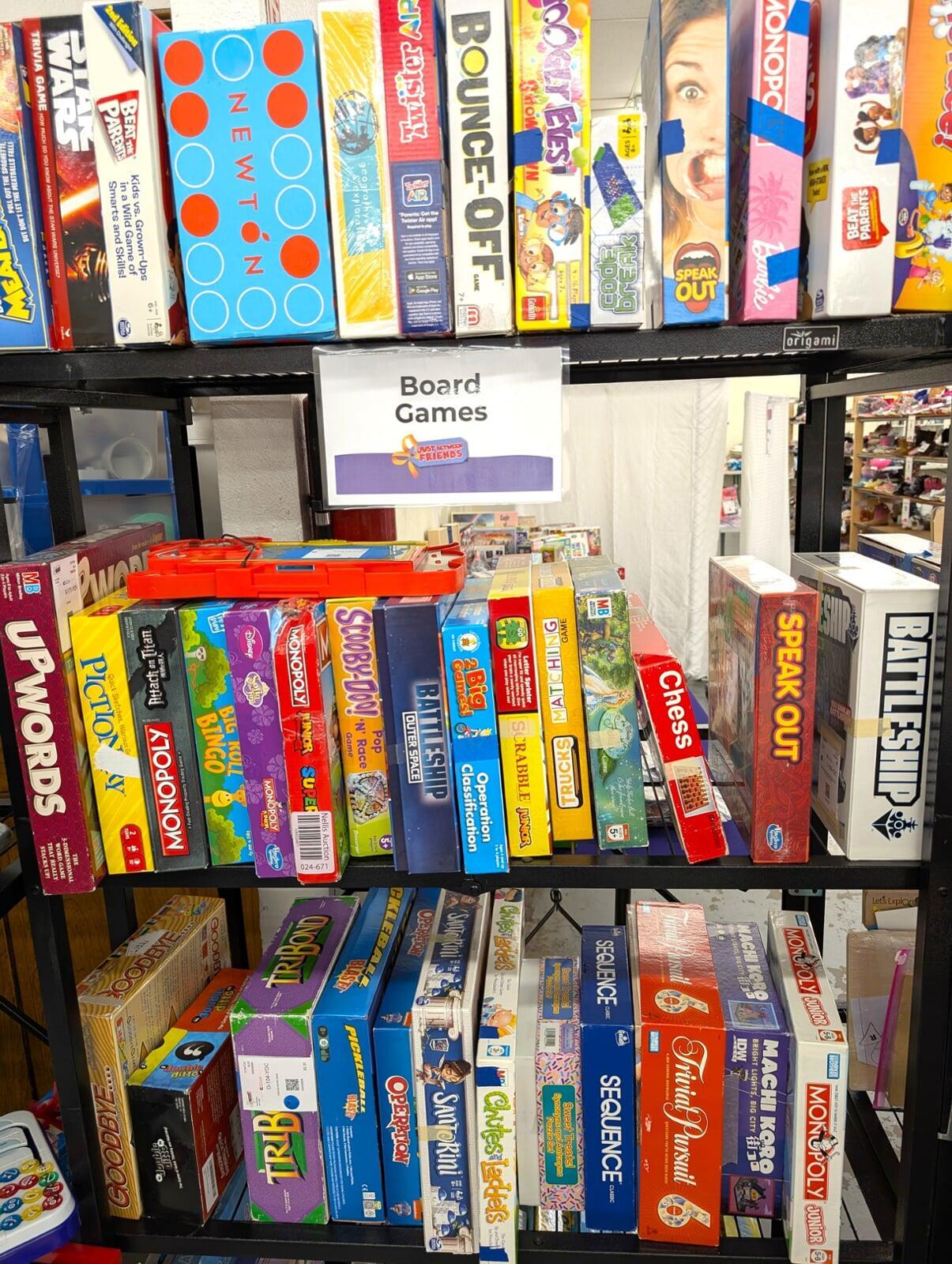 Three rows of board games with a sign that reads Board Games